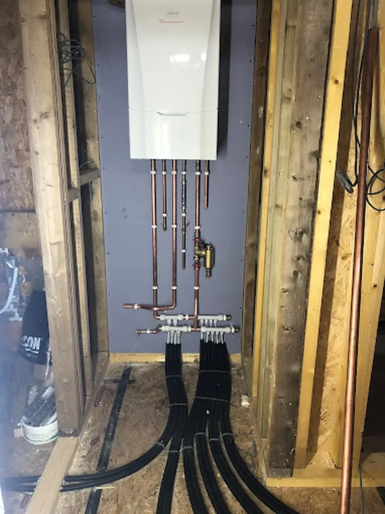 Ideal boiler on a stud wall with copper pipework and a manifold