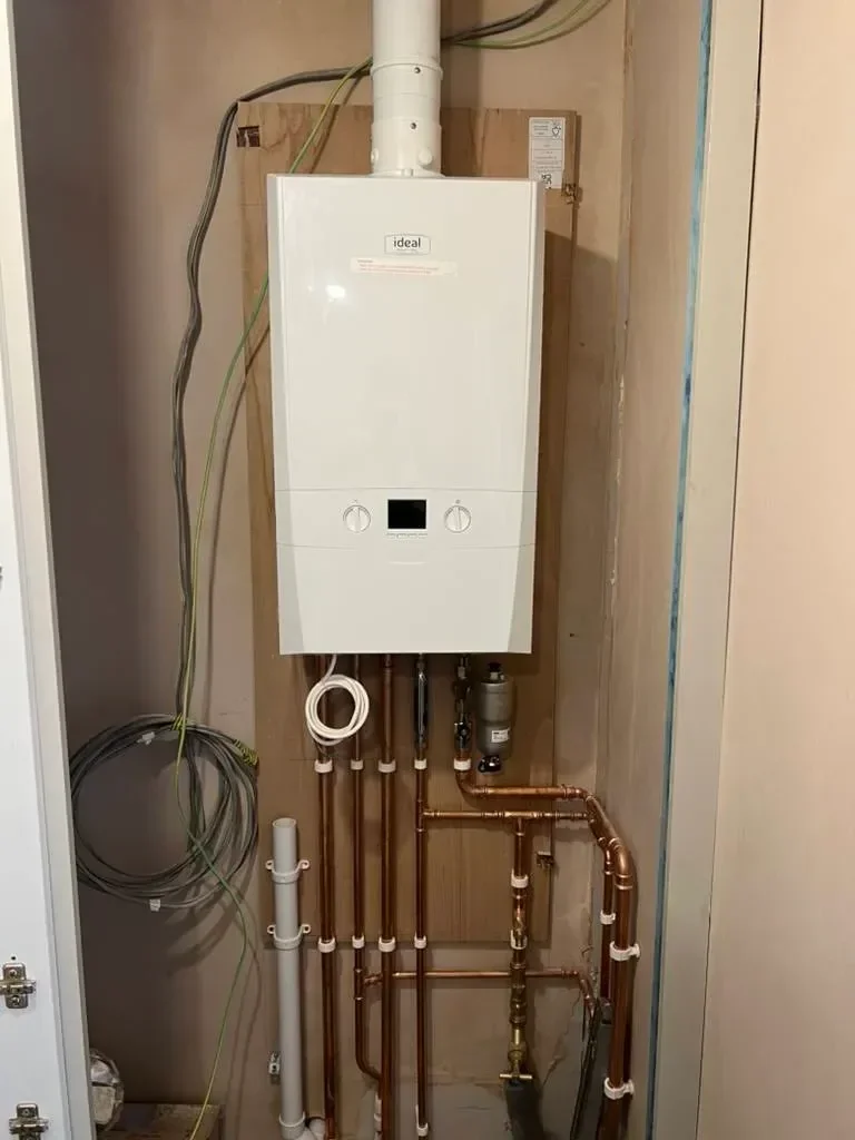 New gas boiler and copper pipework fitted in a cupboard by Plumb Guys Ltd