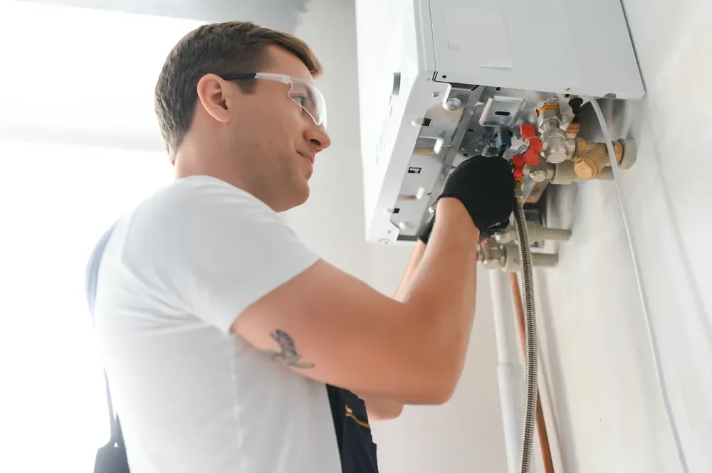 Gas engineer working on a wall-mounted boiler